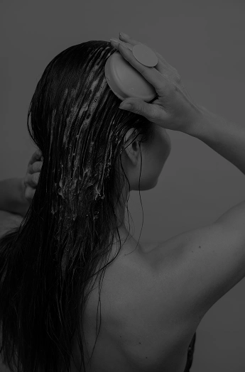 Нанасяне на хидратираща маска с четка върху мокра коса с професионална козметика